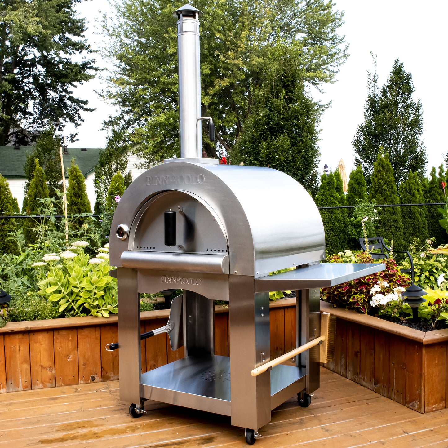 PINNACOLO | PREMIO Wood Fired Outdoor Pizza Oven with Accessories - PPO102 on a deck 