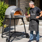 PINNACOLO | IBRIDO (HYBRID) Gas/Wood Pizza Oven With Accessories - PPO103  with guy holding a peel 